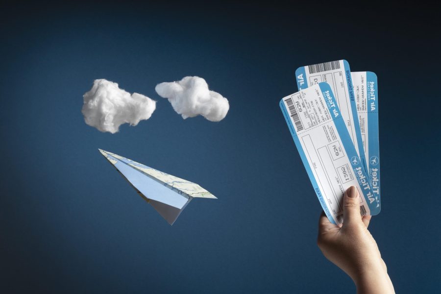 close-up-hand-holding-plane-tickets