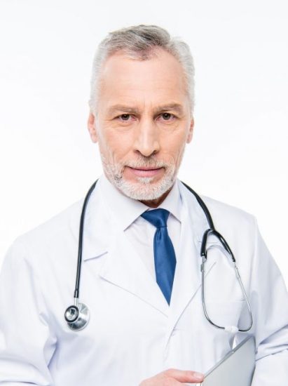 smiling-mature-male-doctor-with-stethoscope-holding-laptop-isolated-on-white-e1625182645470.jpg